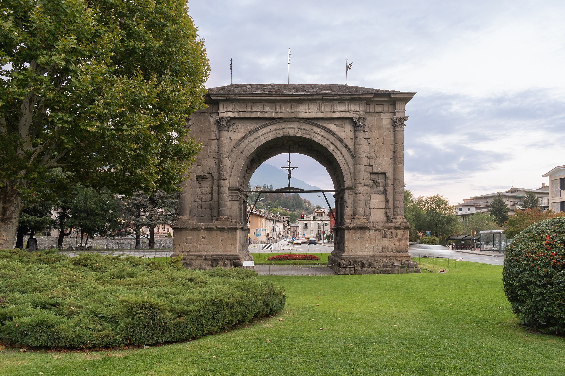 l arco di augusto ad aosta con il tetto in ardesia, le semicolonne corinzie e il crocifisso appeso sotto la volta