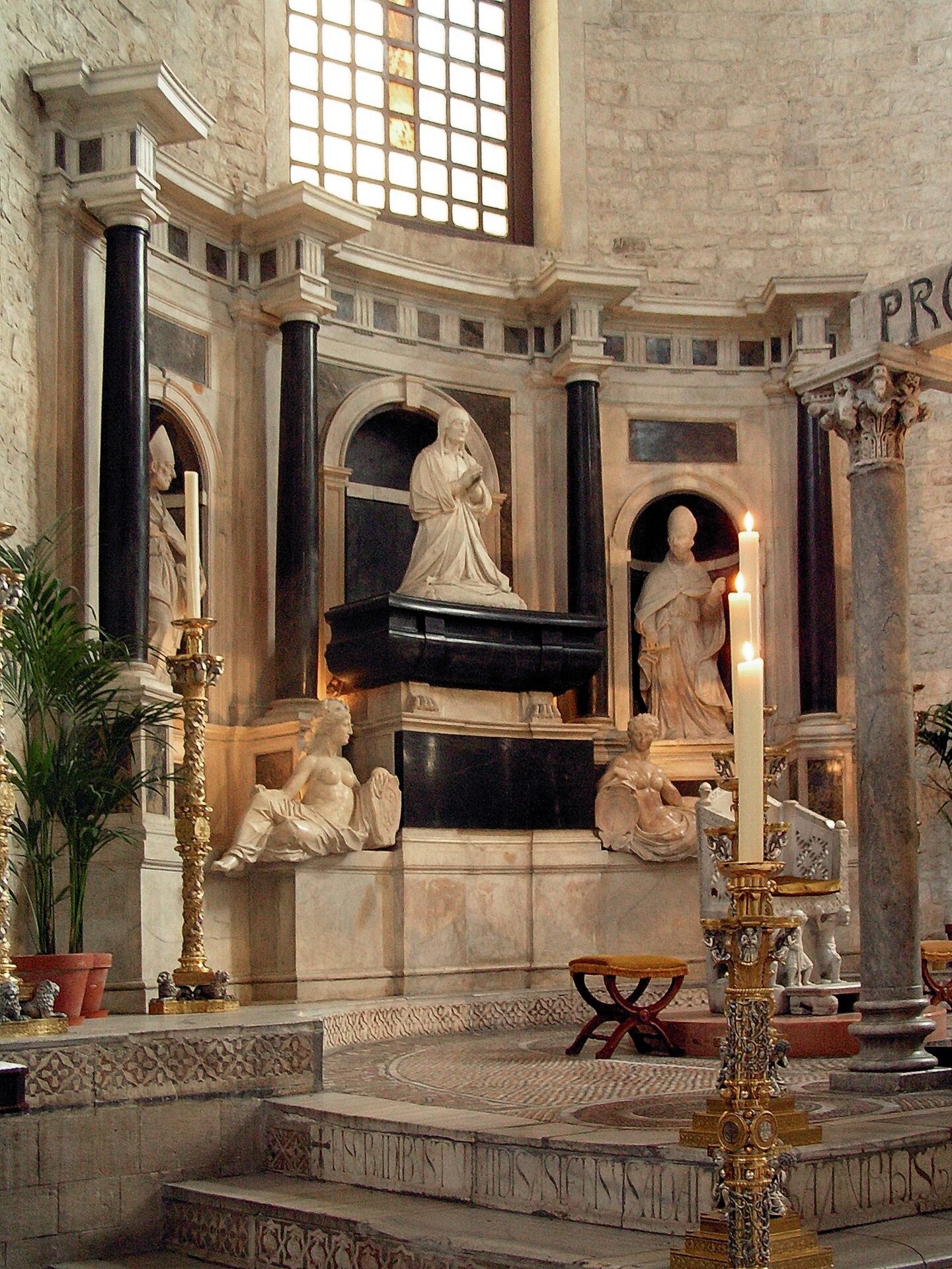 the funerary monument of bona sforza in the basilica of san nicola in bari with the queen kneeling between two saints