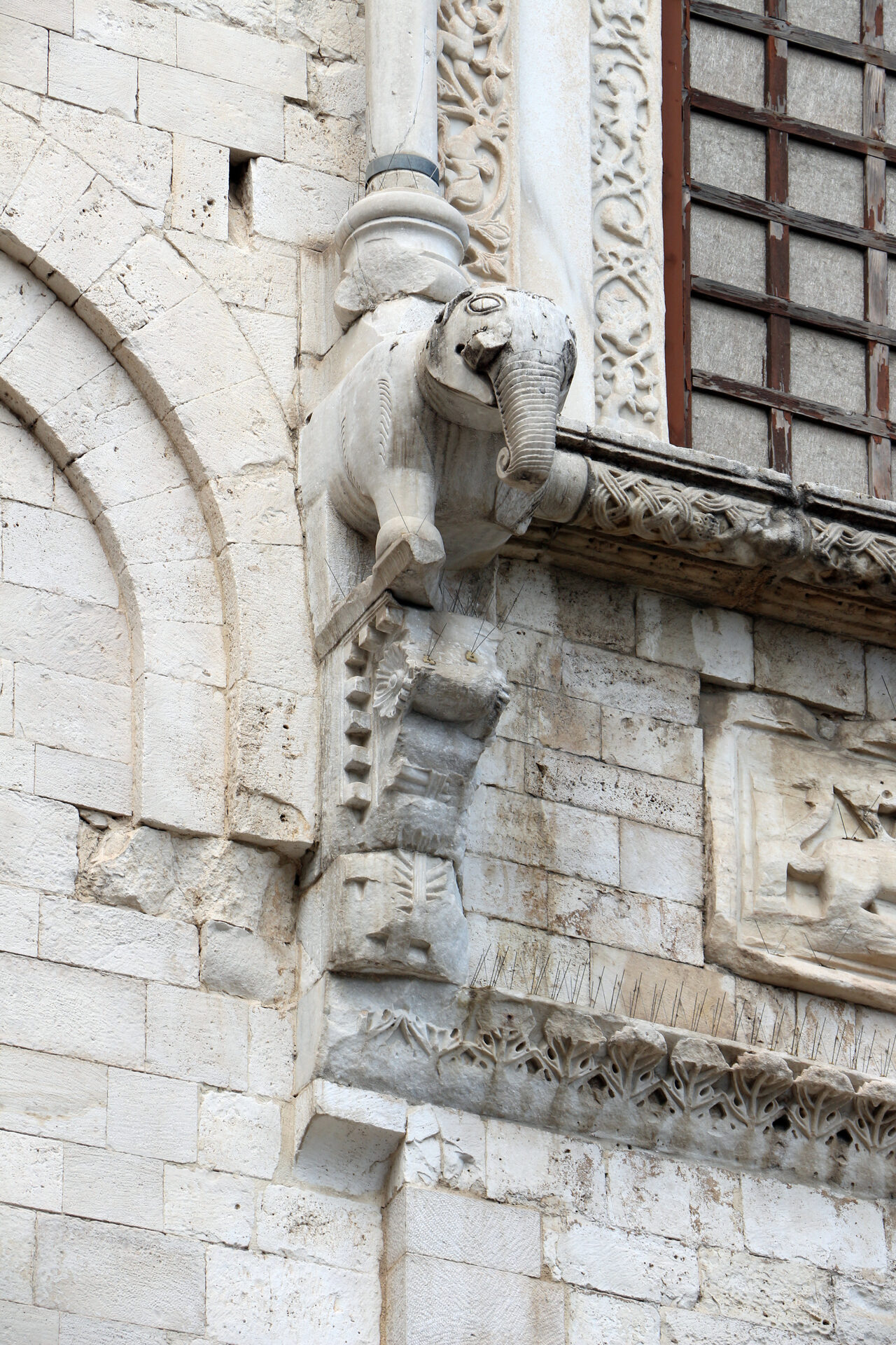 the apse window of the basilica of san nicola in bari carried on a bracket carved as an elephant