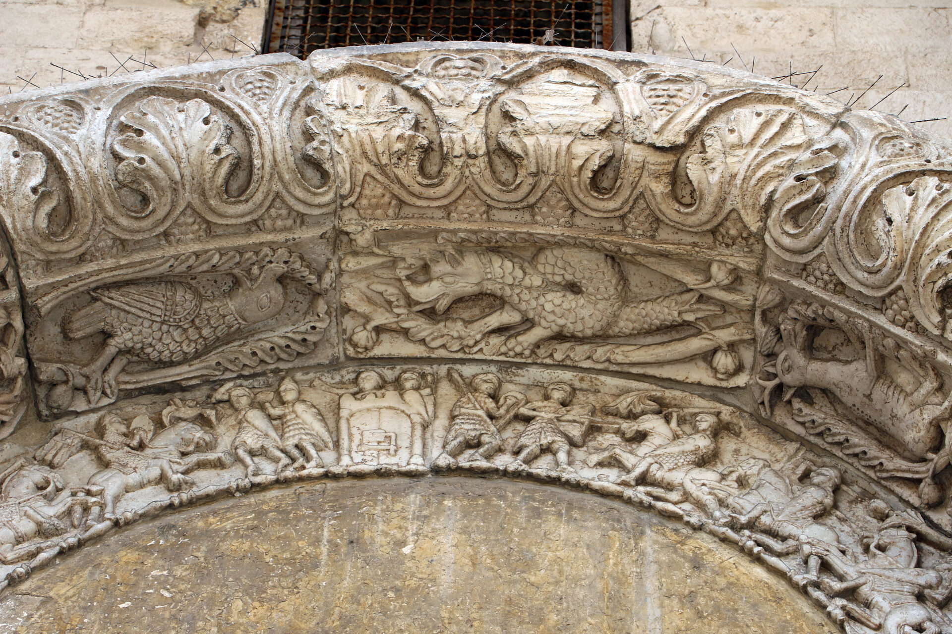 the carved frieze with the battle scene and mounted knights on the porta dei leoni of the basilica of san nicola in bari