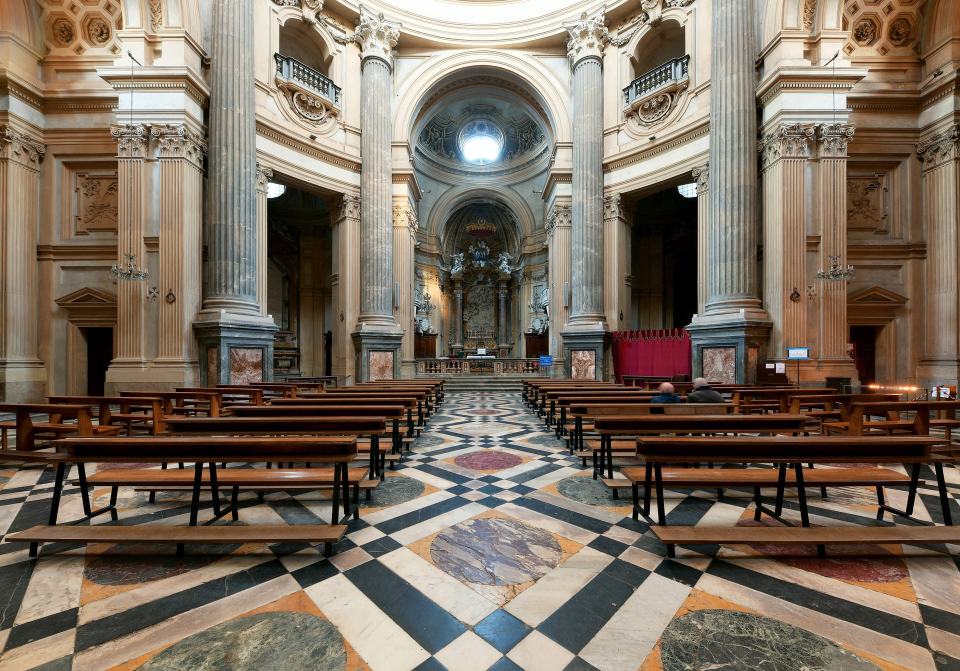 the interior of the basilica of superga, with its circular hall, chapels and columns