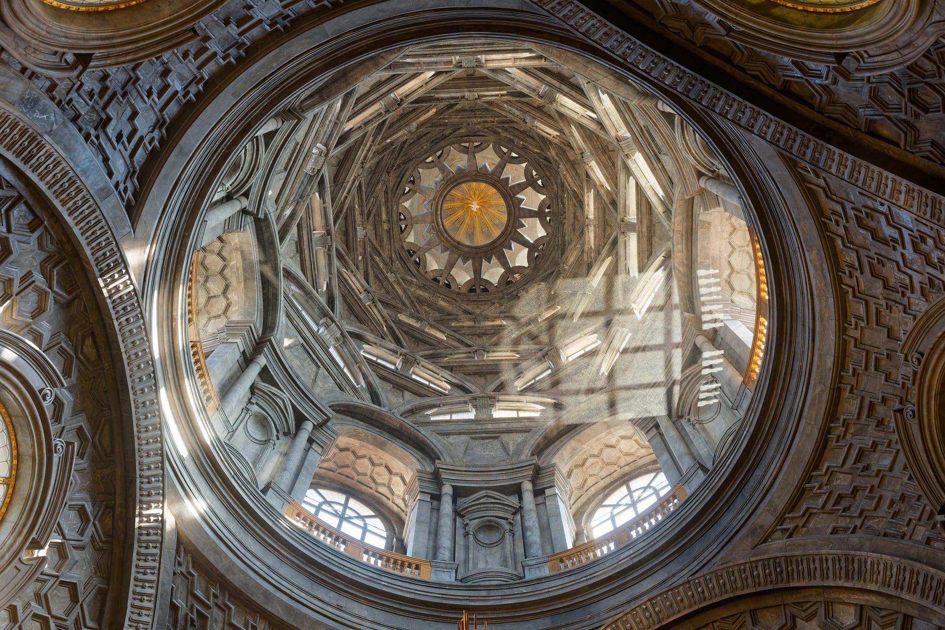 the dome of guarino guarini chapel of the holy shroud seen from below, with six tiers of stacked arches and the star shaped lantern