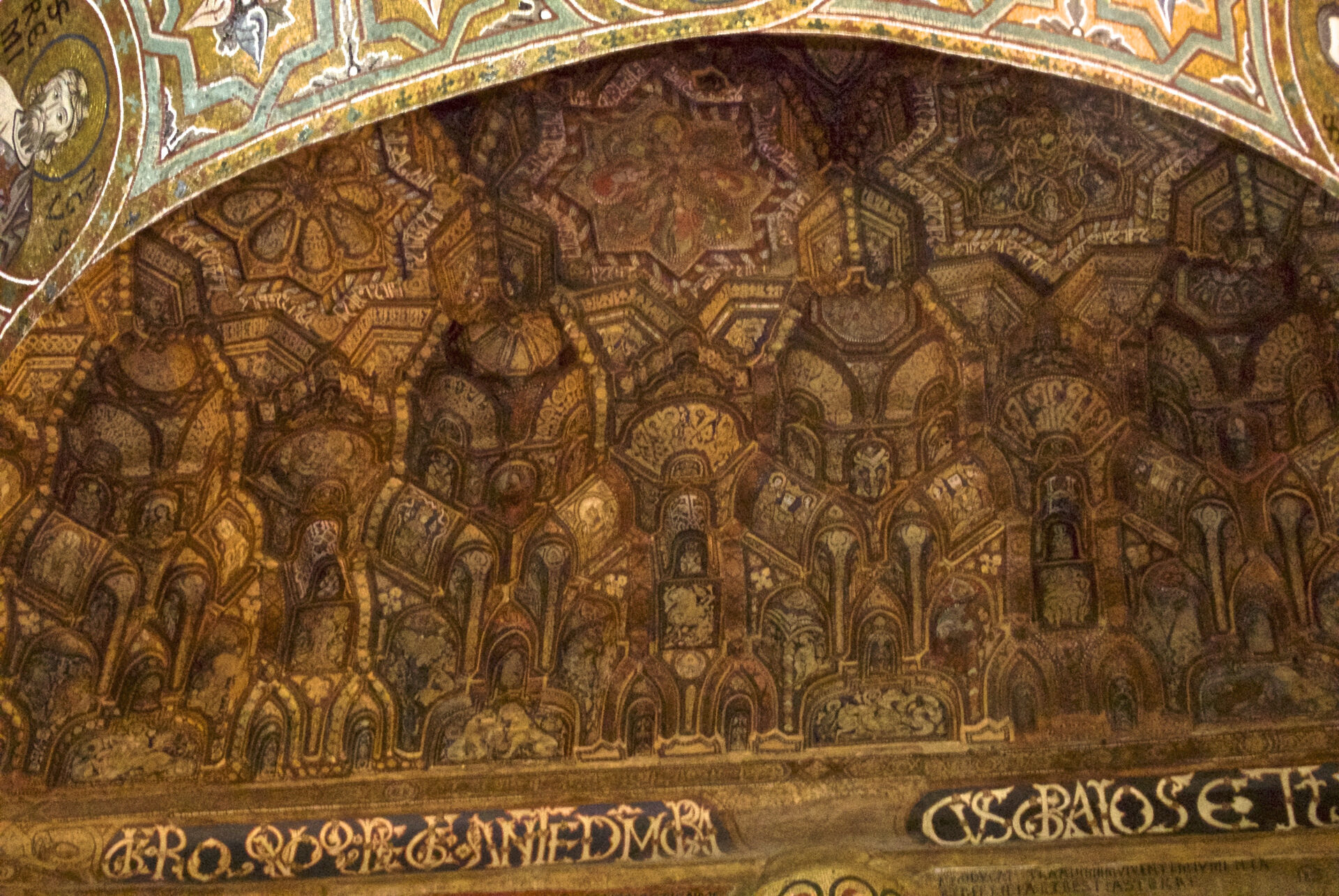 the wooden muqarnas ceiling of the palatine chapel with painted honeycomb cells and inscriptions