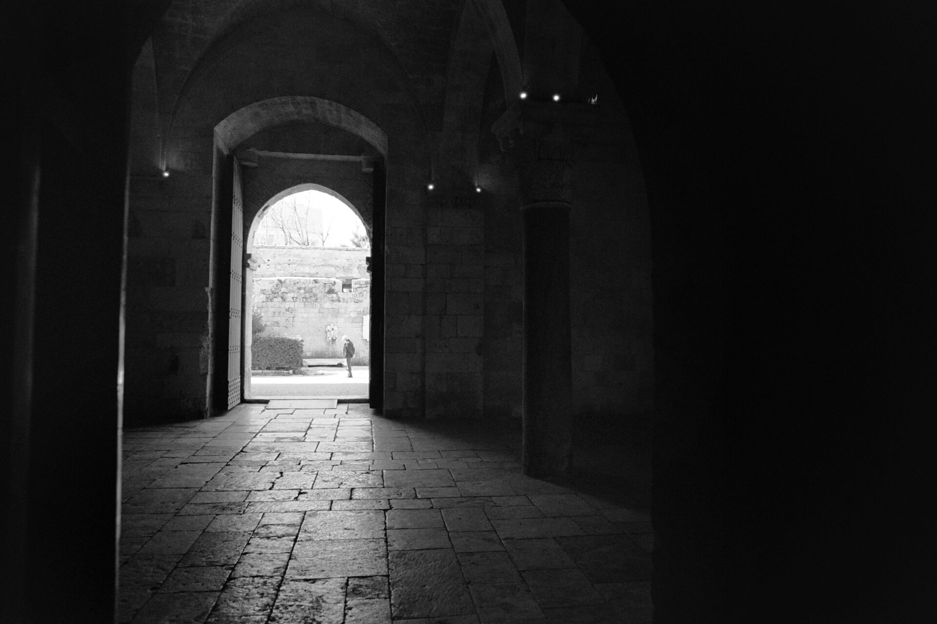 the internal portico of the swabian castle of bari with its stone vault and the light coming from the courtyard