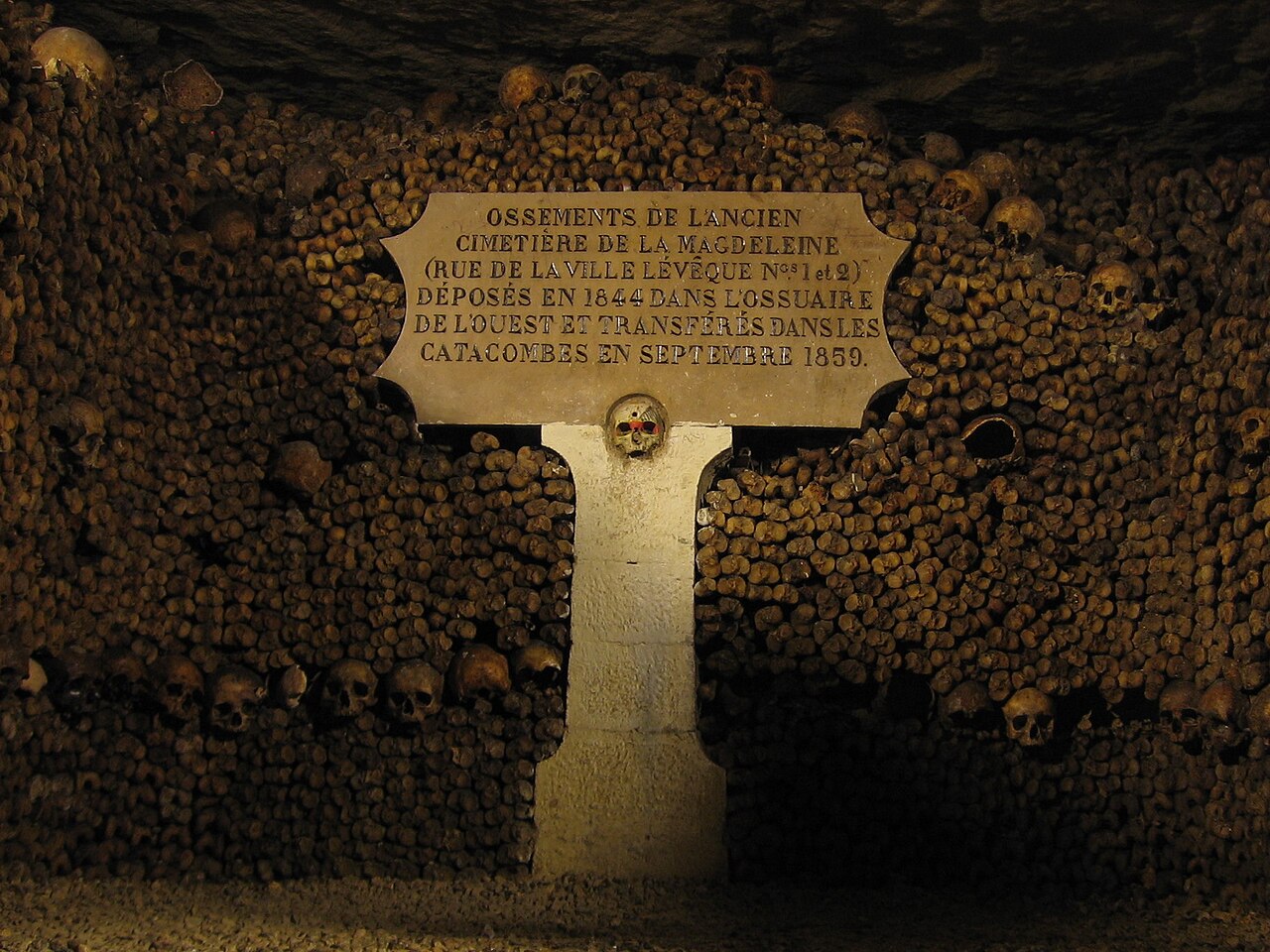 una targa di pietra murata fra due pareti di ossa: dichiara che le ossa dell antico cimitero della madeleine, depositate nel 1844 nell ossario dell ovest, furono trasferite nelle catacombe nel settembre 1859, e sotto la targa c e un teschio isolato al centro di un pilastro bianco