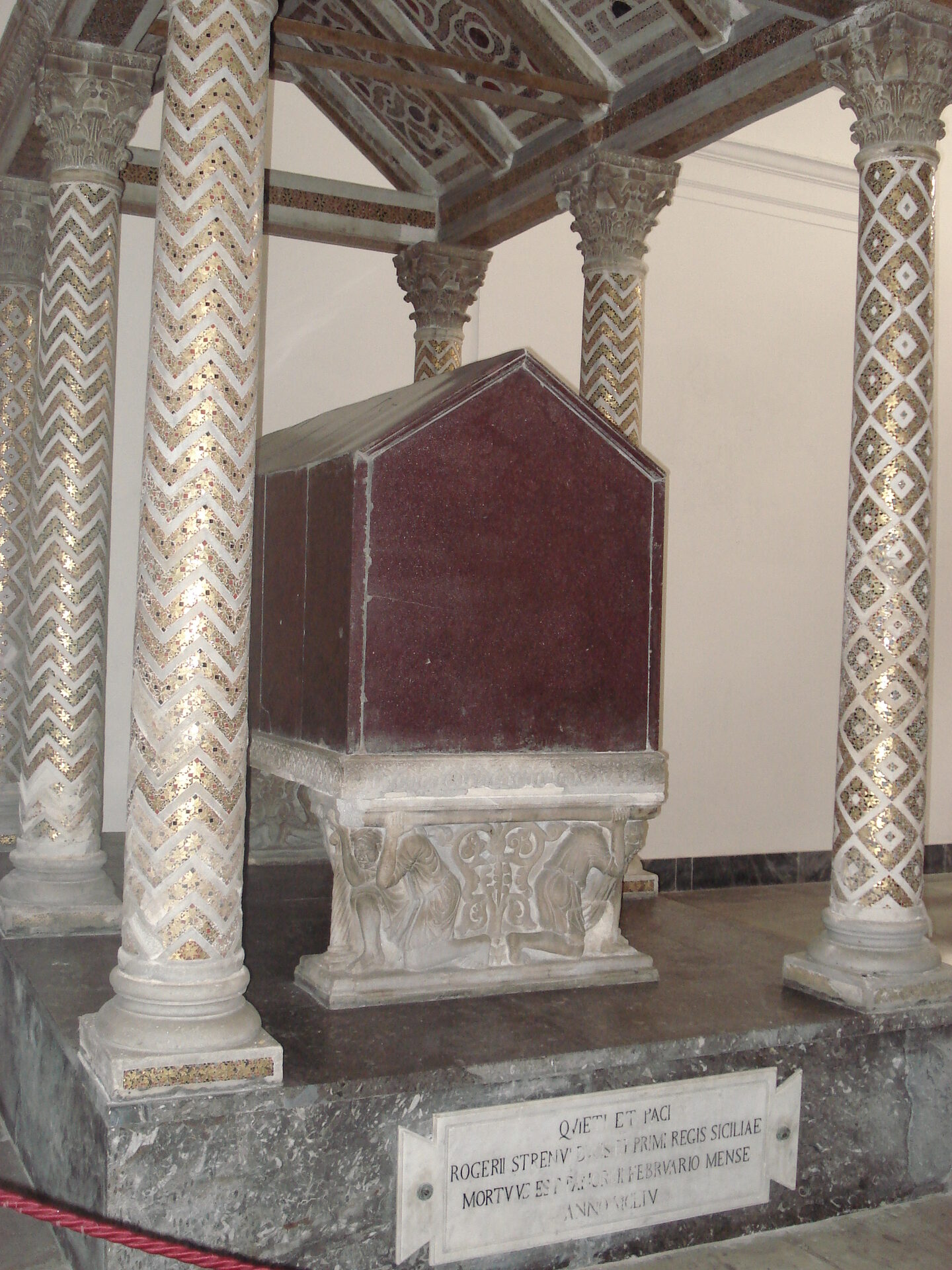the red porphyry sarcophagus of roger ii under its columned canopy in palermo cathedral