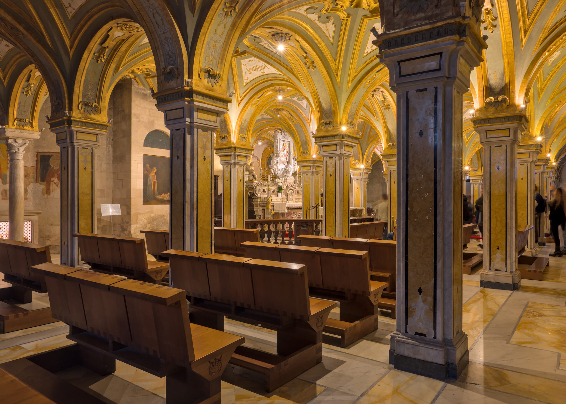 the baroque crypt of the cathedral of san sabino in bari with its gilded vaults and dark marble columns
