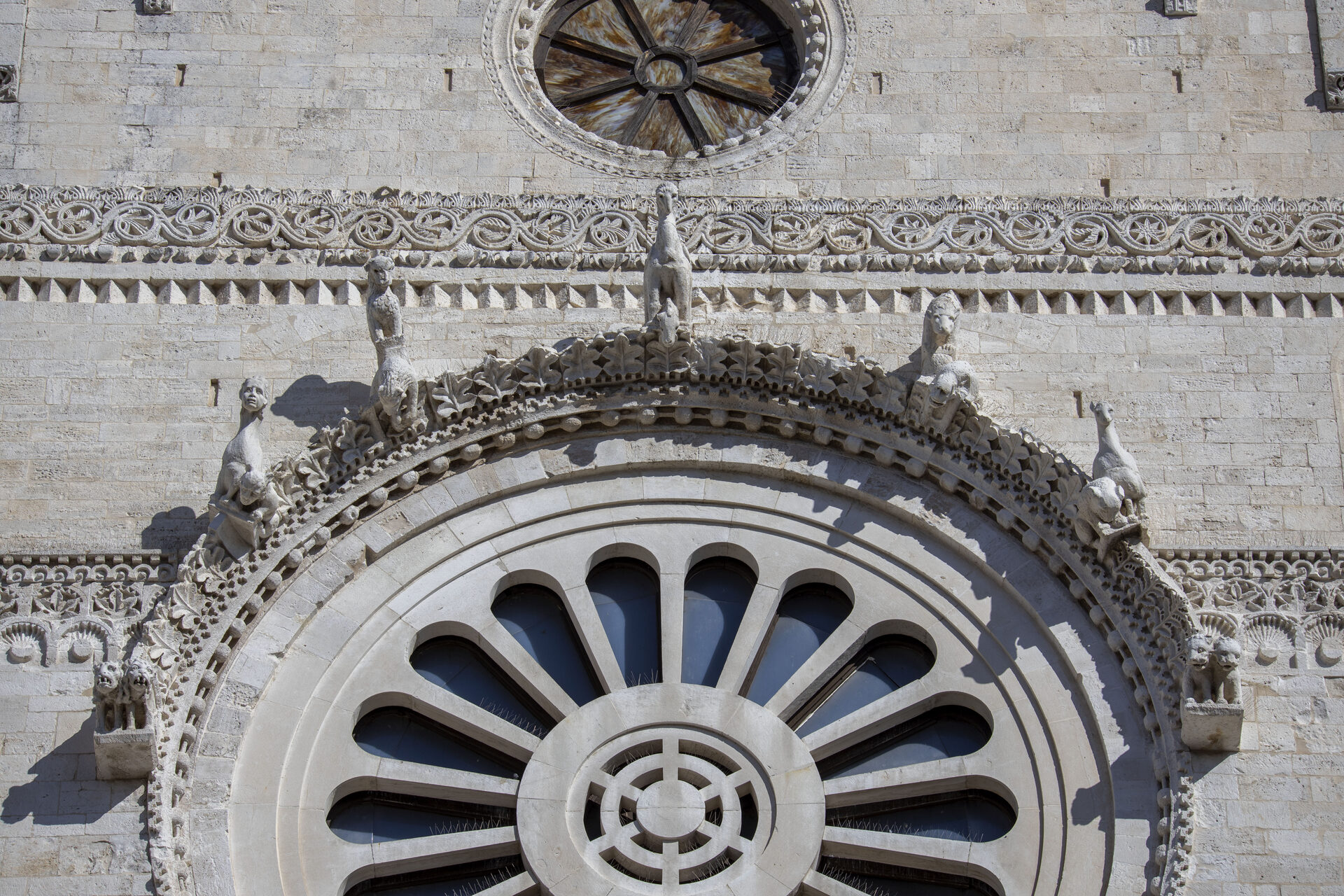 the grotesque corbels around the rose window of the cathedral of san sabino in bari
