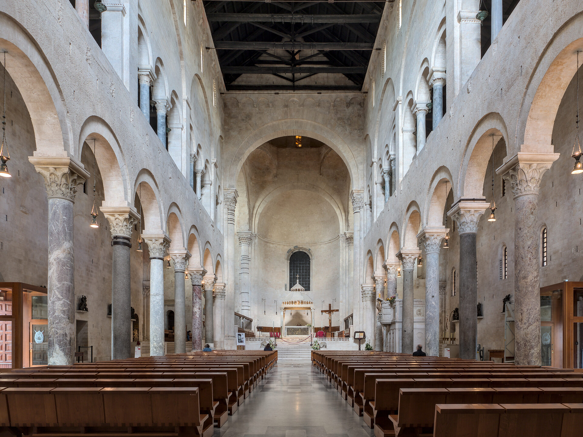 the nave of the cathedral of san sabino in bari with its pale columns and open roof trusses