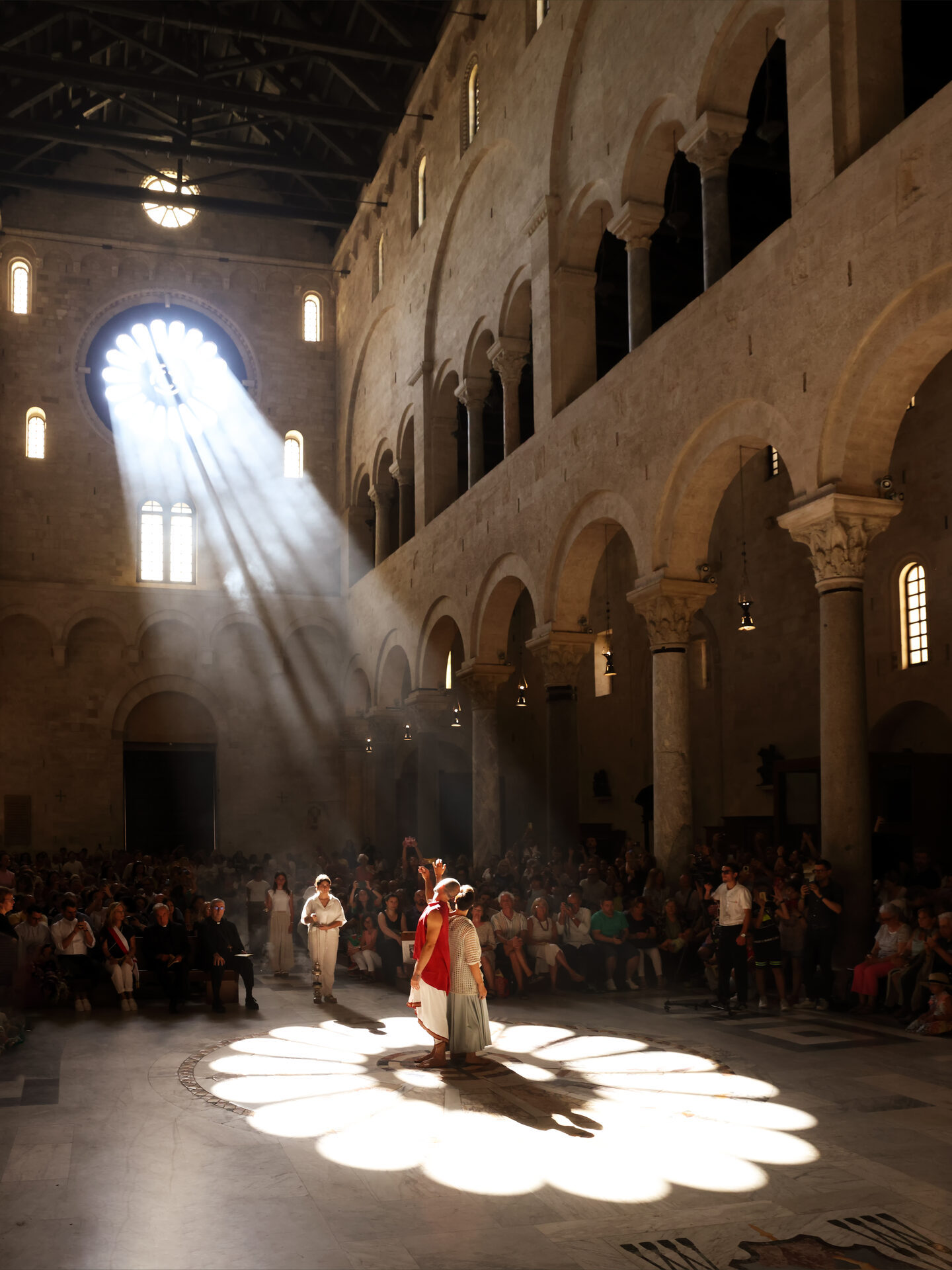 the disc of light cast by the rose window on the floor of bari cathedral on the day of the summer solstice