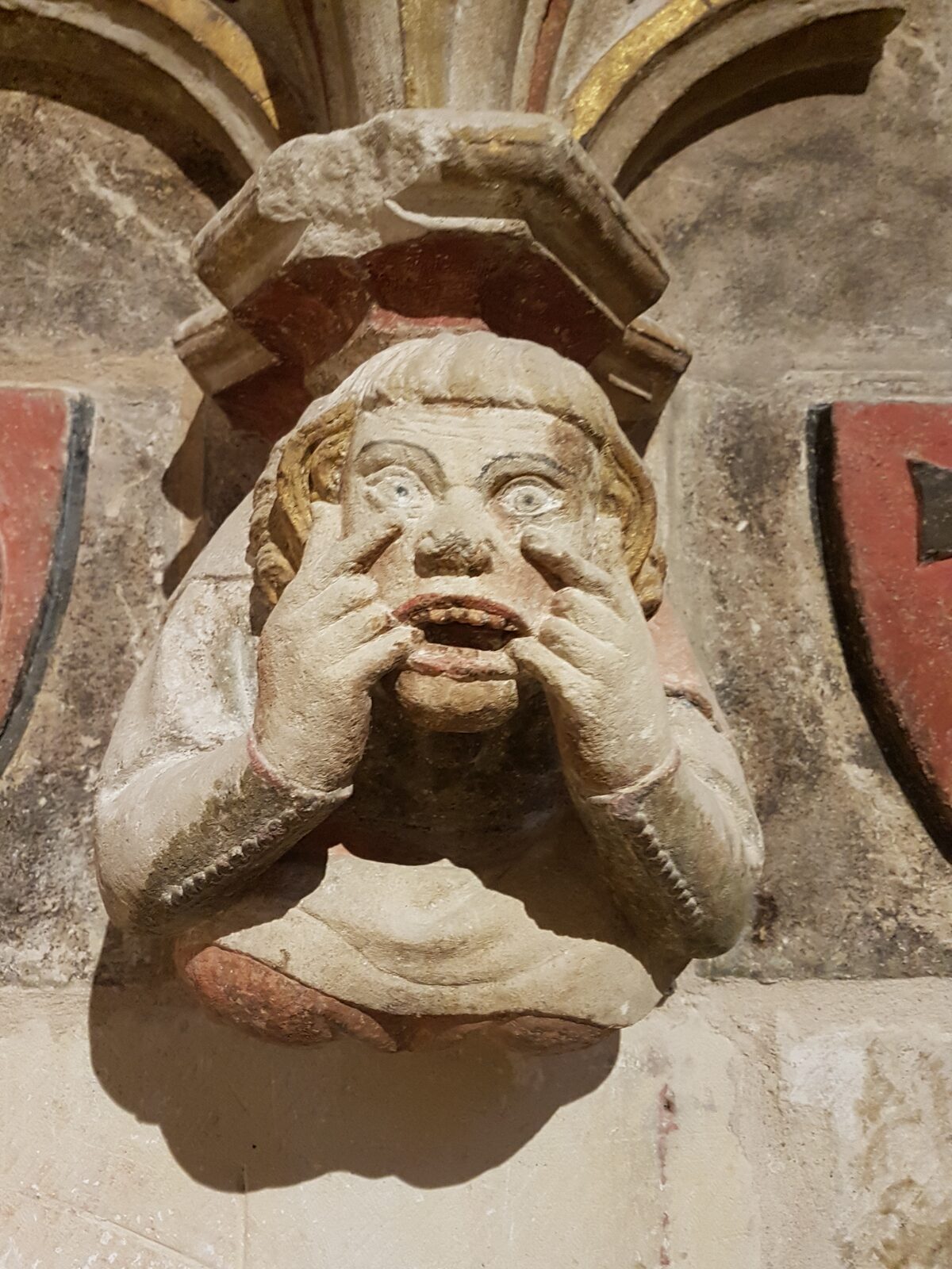 a carved mask corbel in Tarragona Cathedral, still keeping traces of polychromy