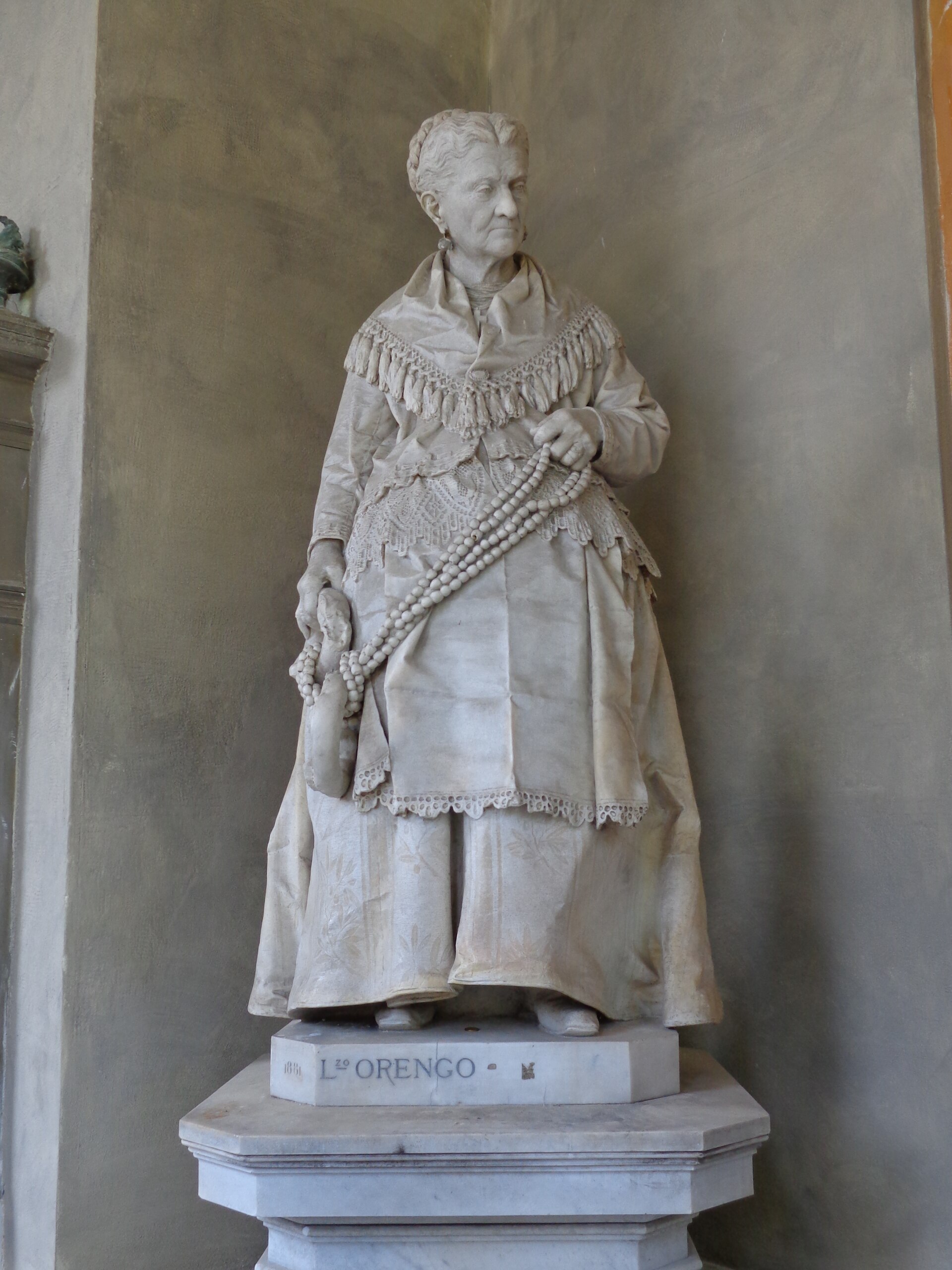 statue of caterina campodonico with the hazelnut necklaces at staglieno cemetery