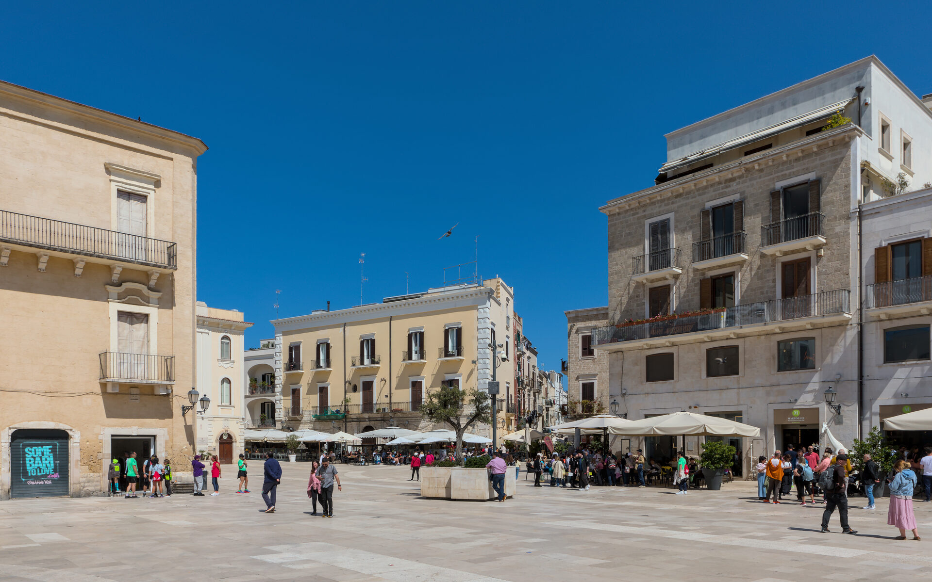 piazza mercantile in bari with the tables of the bars and the palaces closing it on three sides