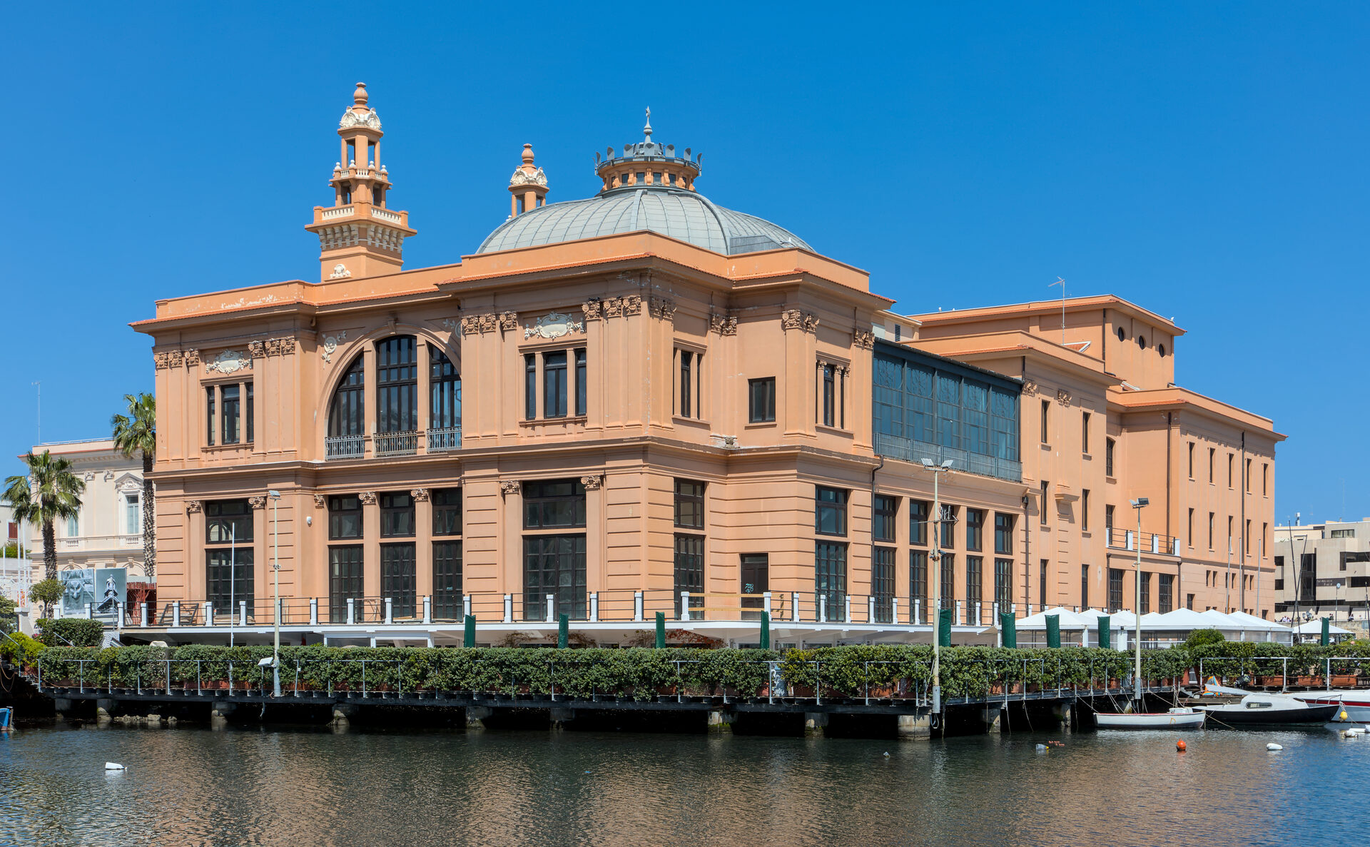 the teatro margherita of bari seen from the water, standing on its piles inside the old harbour