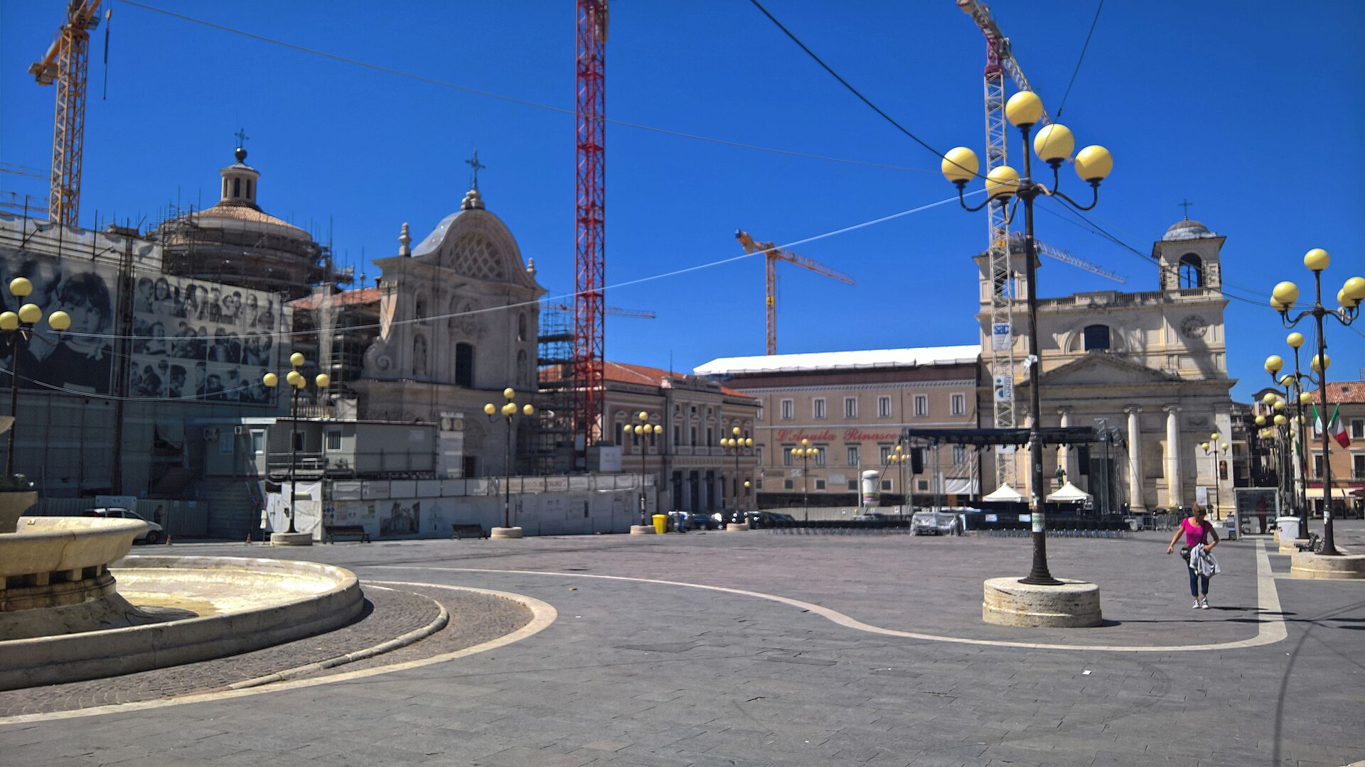piazza del duomo dell aquila nell agosto 2017 con la cattedrale sotto i ponteggi tre gru e la piazza vuota