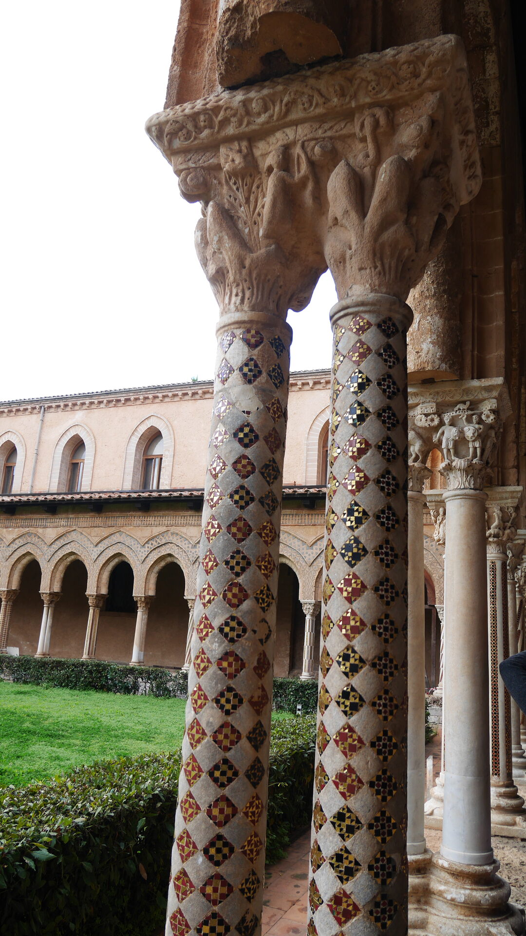 the paired columns of the benedictine cloister at monreale with their carved capitals