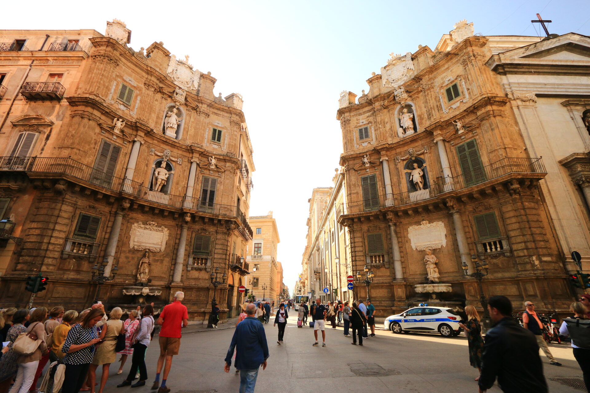 the quattro canti in palermo with the concave baroque facades and people at the crossing