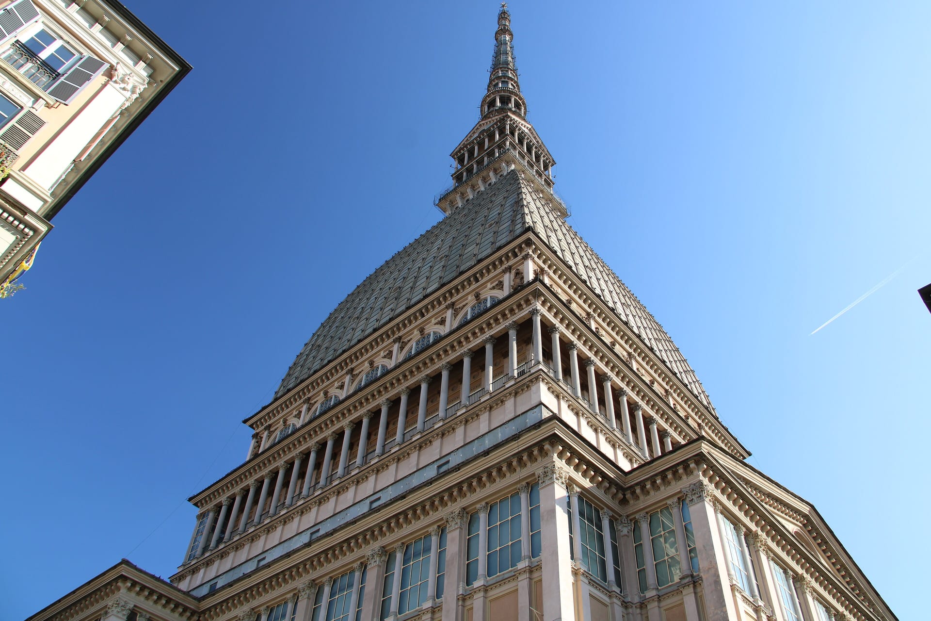 the mole antonelliana in turin seen from below with its scaled dome and the spire against the sky