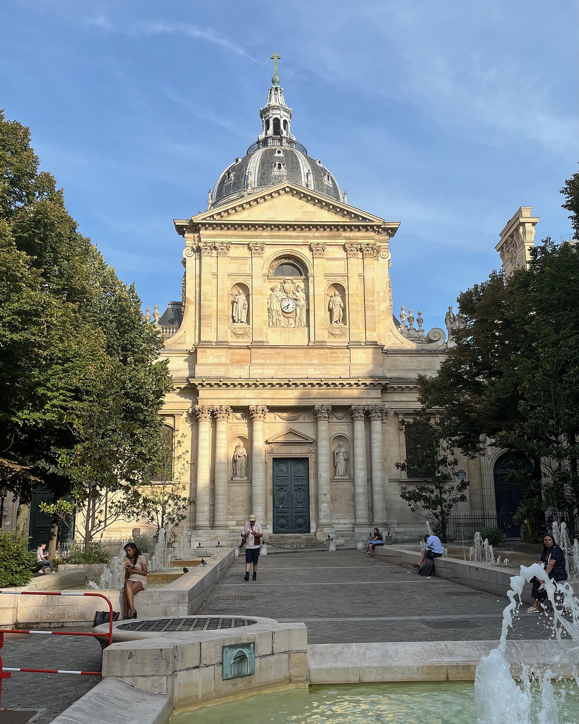la cappella della sorbonne a parigi con la cupola e il tamburo di pietra chiara, la facciata a due ordini con le statue nelle nicchie e i getti della fontana nella piazza davanti