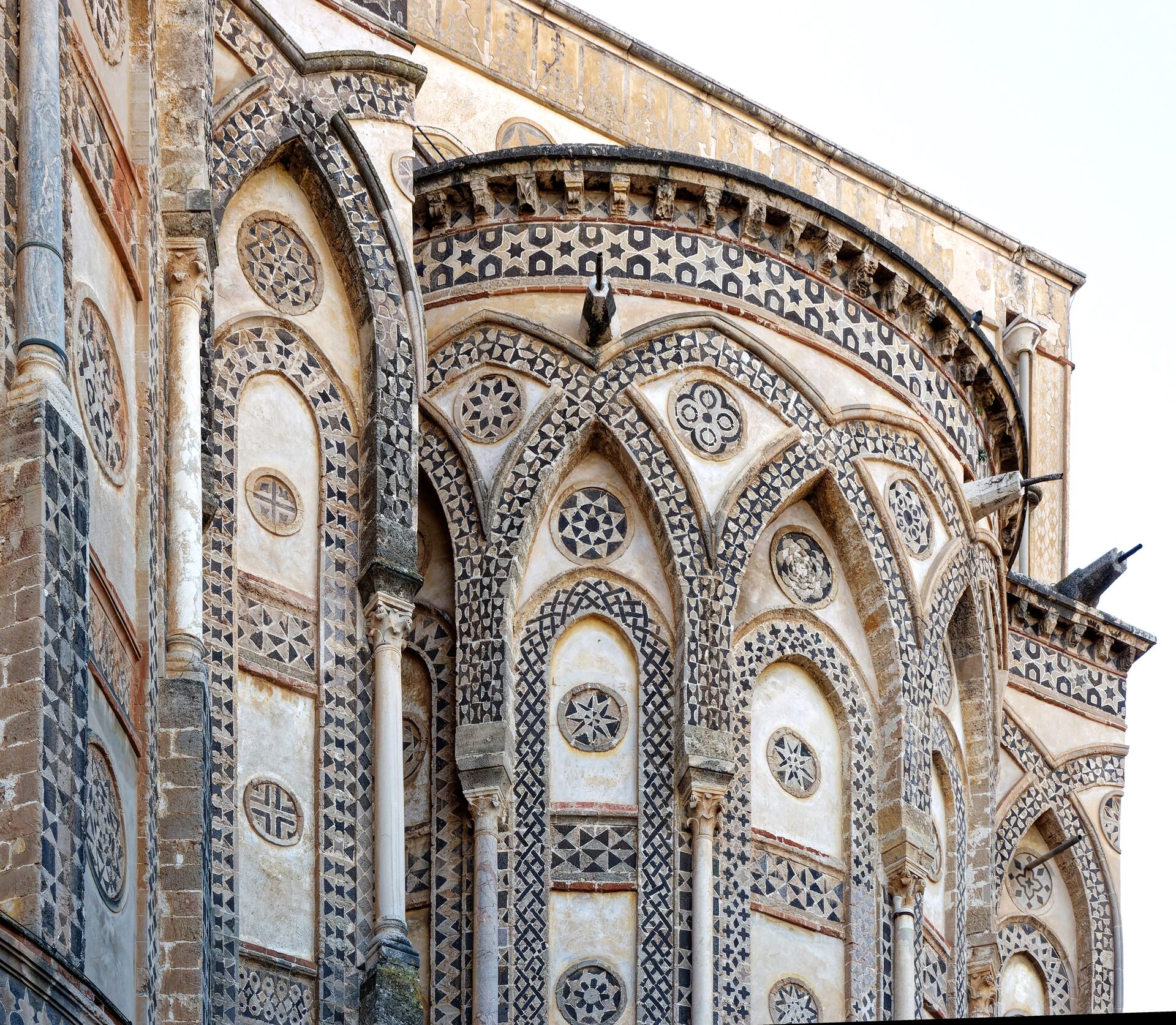 the apses of monreale cathedral with interlacing arcading and geometric lava stone inlay