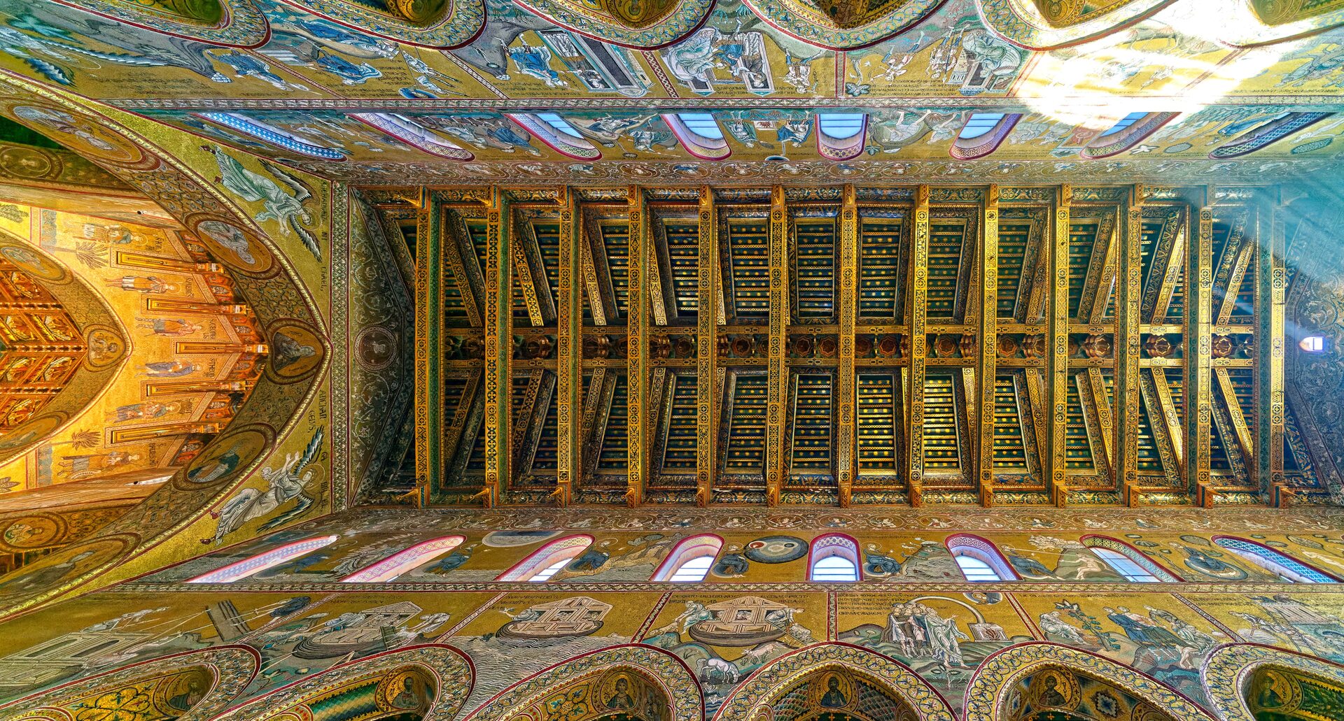 the painted timber roof of monreale cathedral above the golden mosaics