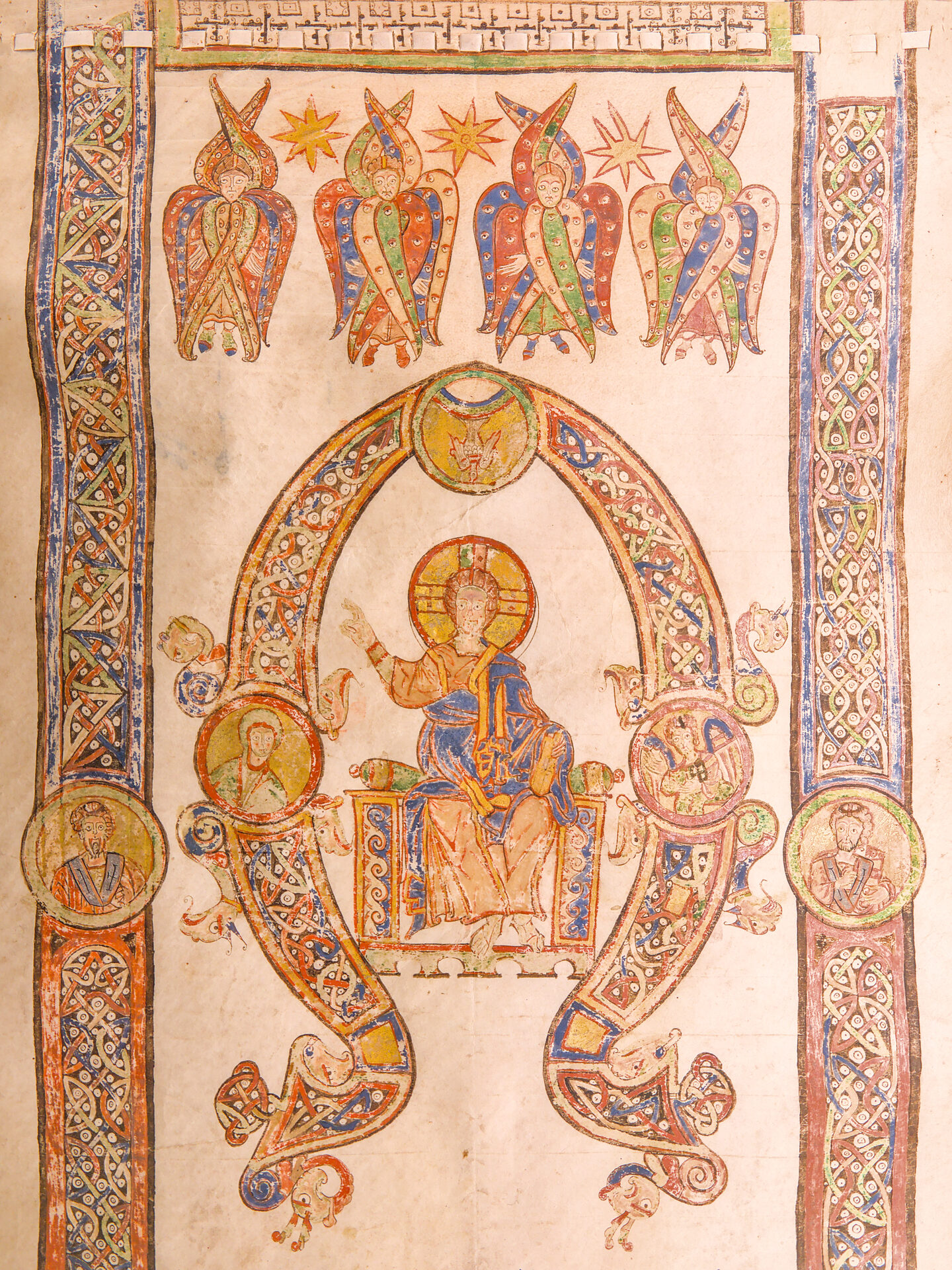 a miniature from the bari exultet with christ enthroned inside a decorated letter and seraphim holding the stars