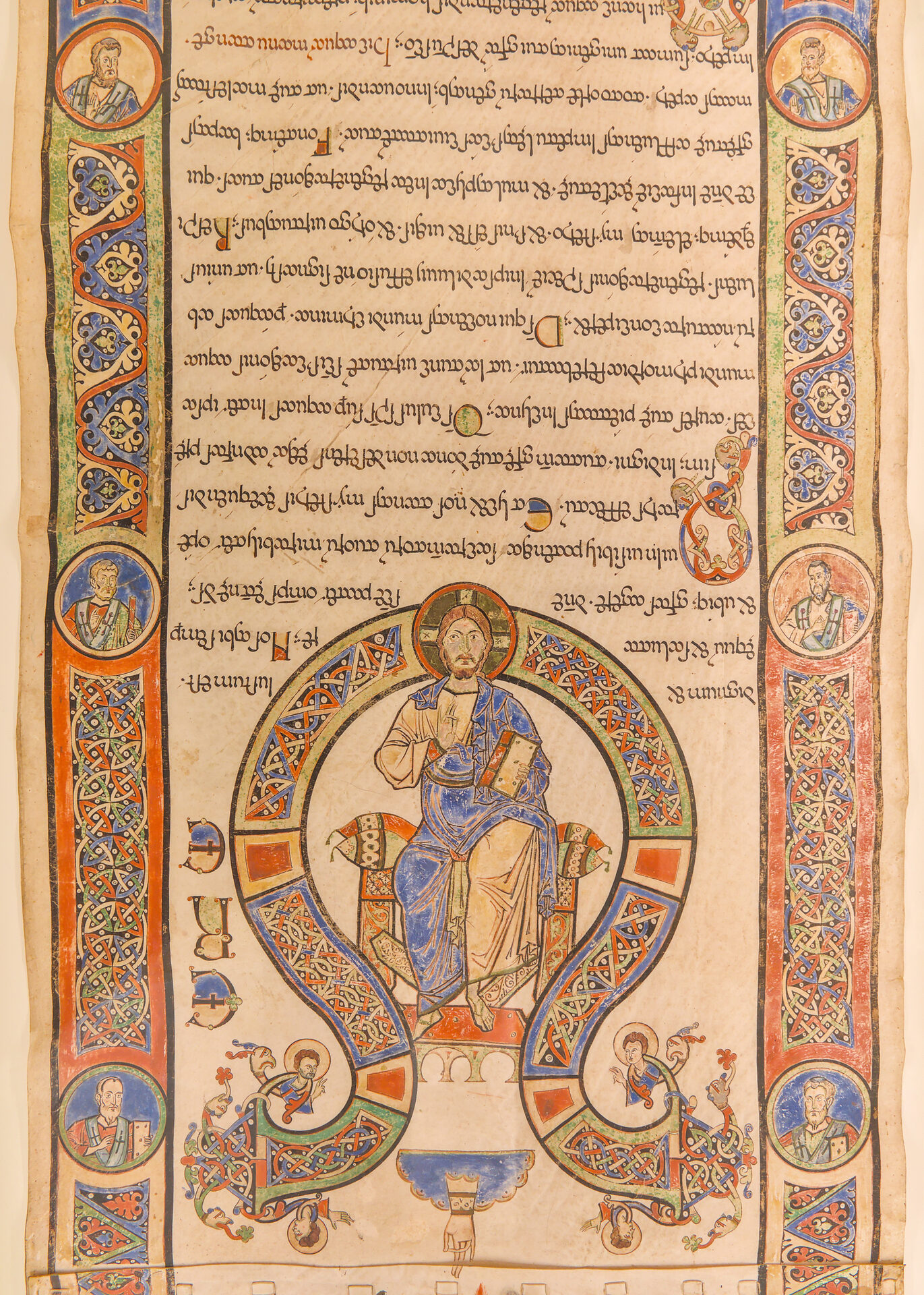 a miniature from a bari exultet with christ enthroned in a mandorla and the evangelist medallions in the border