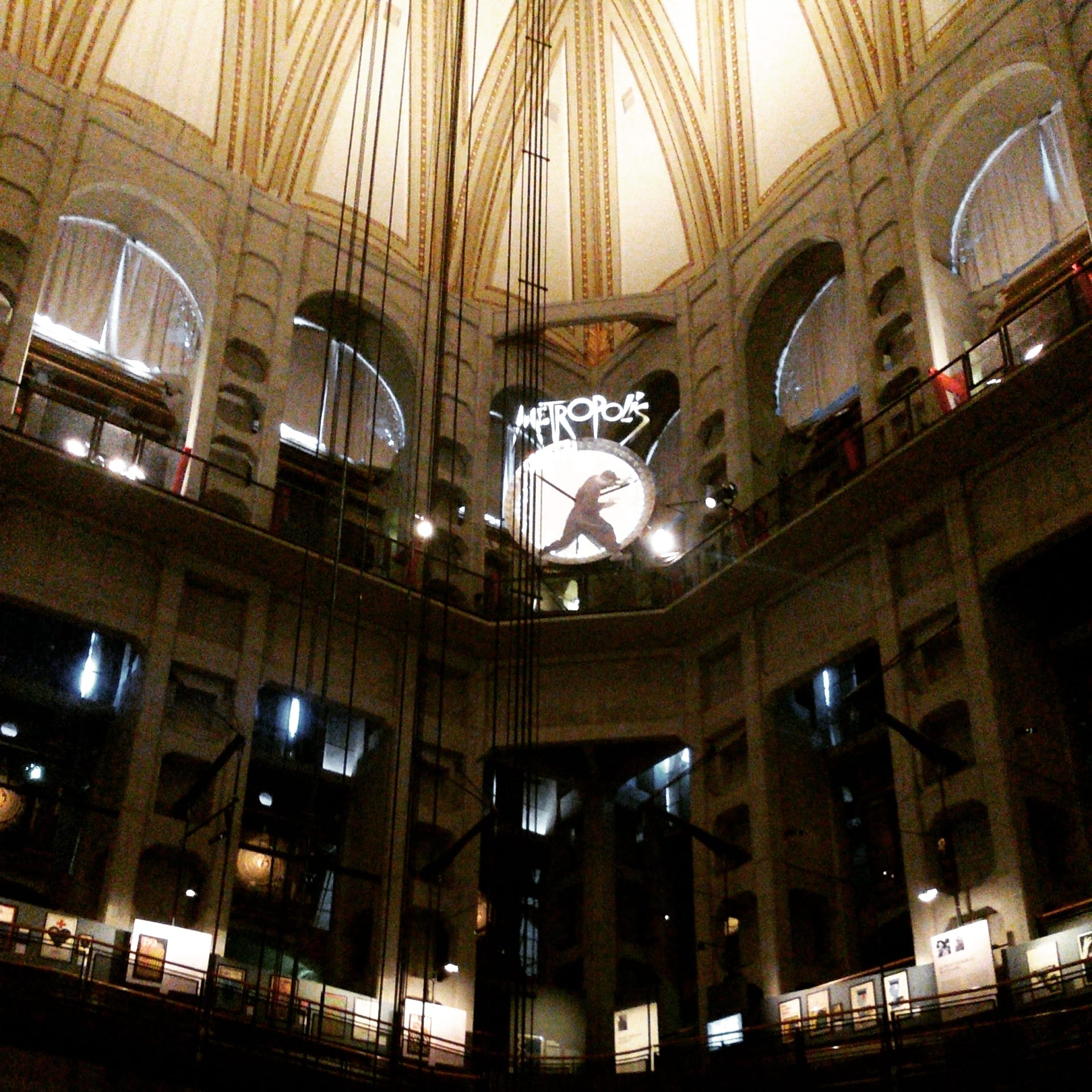 the interior of the mole antonelliana dome seen from below, with the panoramic lift cables dropping through the centre