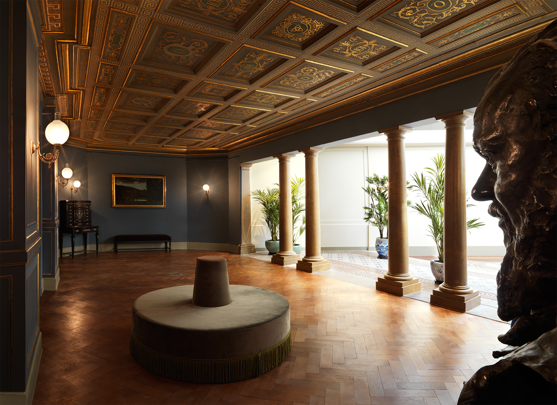 il salone del musee henner con il soffitto a cassettoni dorati e le colonne che si aprono sul giardino d inverno con le palme in vaso