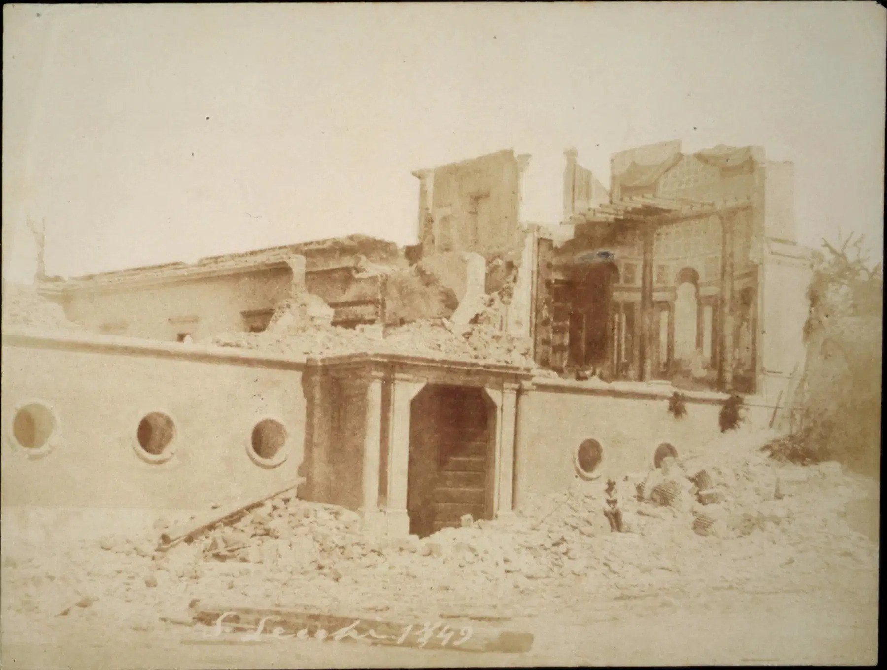 calotipo de stefano lecchi de 1849 con la aranciera de villa borghese reducida a ruina, el tejado hundido, los escombros delante del portal central y la fila de ventanas redondas en el muro bajo, con la firma del fotografo escrita abajo