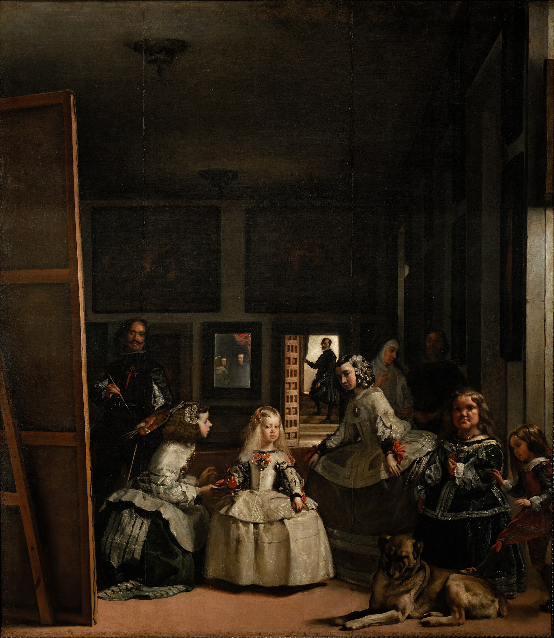 las meninas di velazquez, con l’infanta margarita al centro, le damigelle intorno, il pittore a sinistra davanti a una grande tela, un cane accucciato in primo piano e uno specchio luminoso sulla parete di fondo