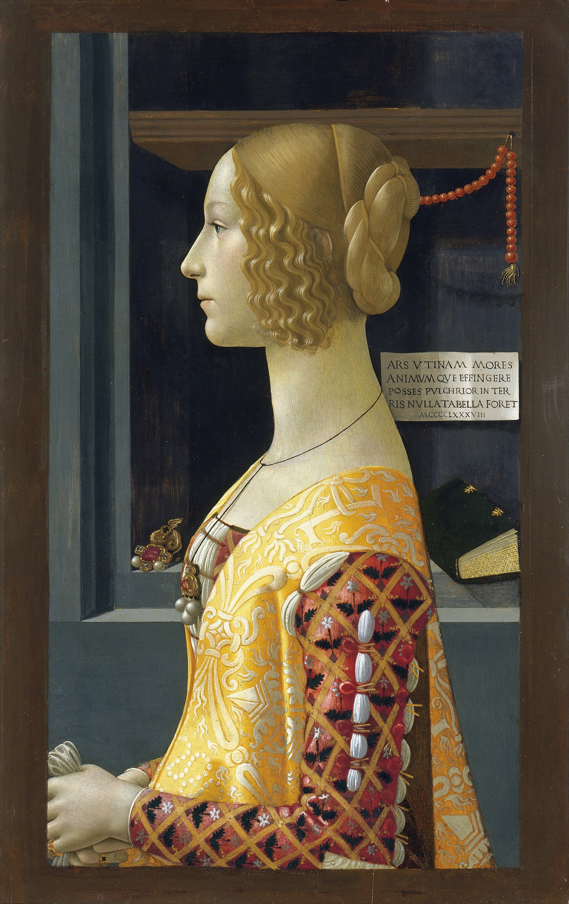 the portrait of giovanna tornabuoni by ghirlandaio, a young woman in profile with her hair gathered up and a yellow and red dress, in front of a niche with an inscribed cartouche, a hanging coral necklace and a book