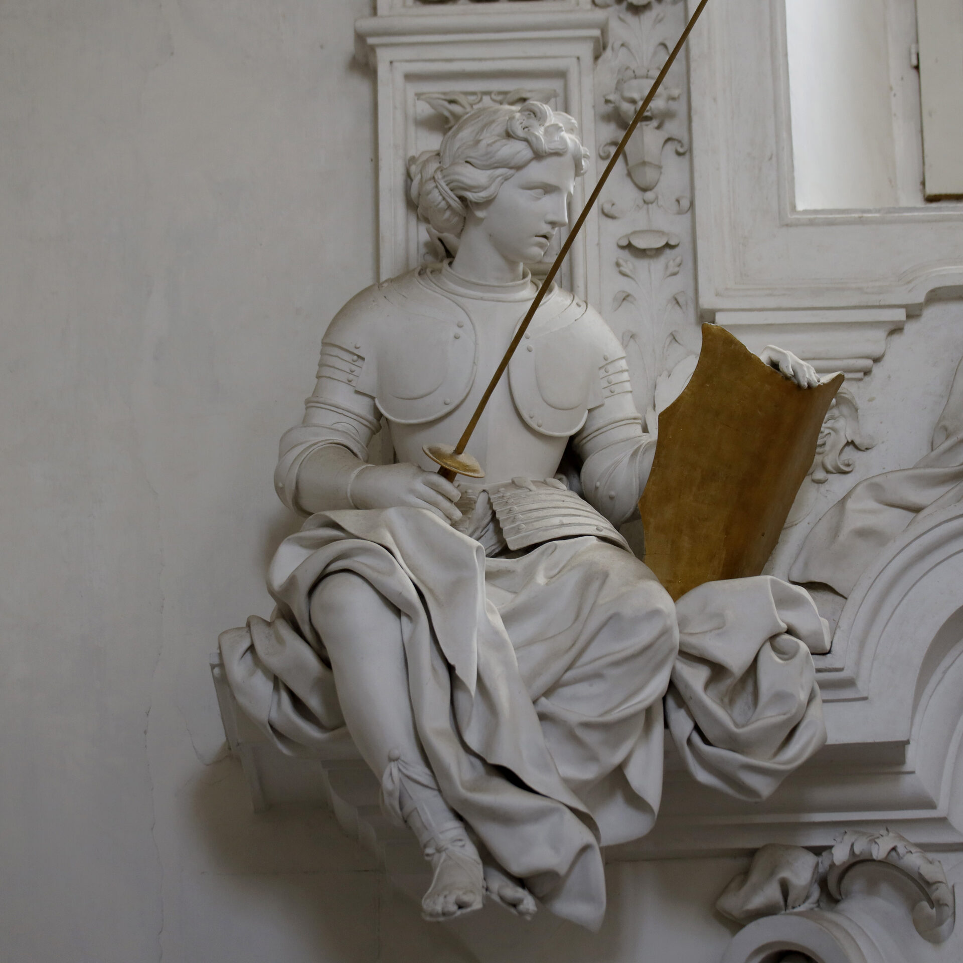 a second allegorical statue by serpotta with modelled drapery and putti at the base