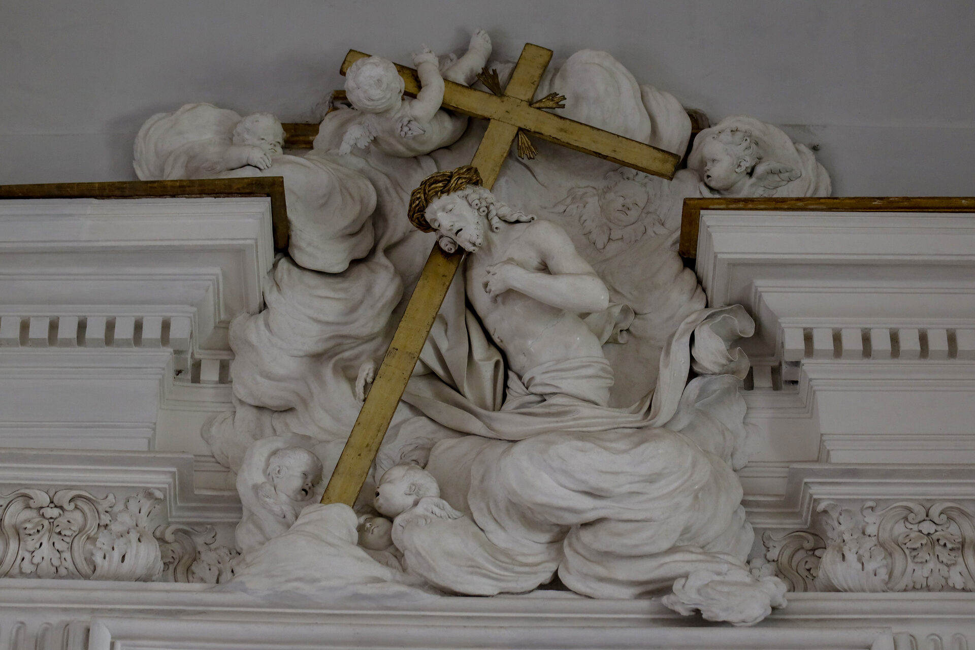serpotta's stucco putti holding the cross in the oratory of san lorenzo in palermo