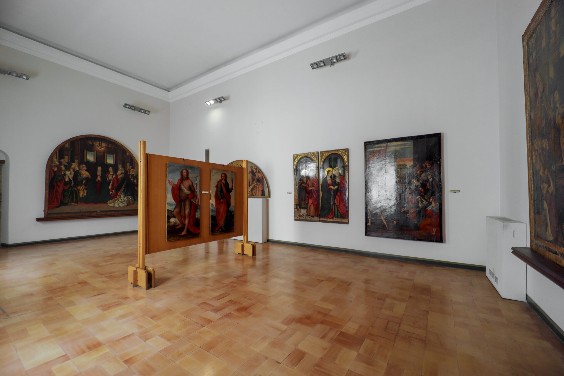 a room in palazzo abatellis installed by carlo scarpa with paintings on easels held clear of the wall