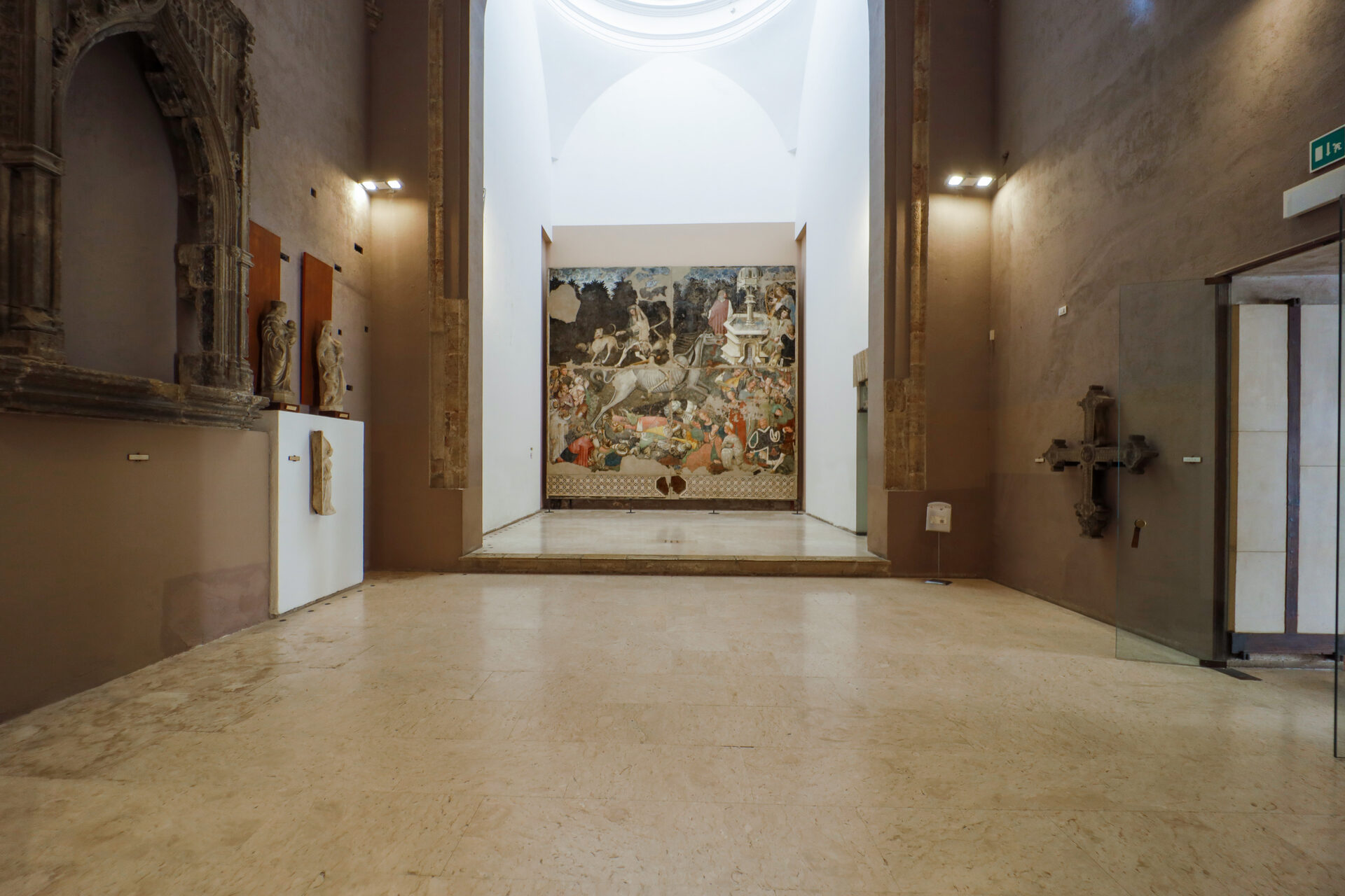 the corridor of palazzo abatellis with the triumph of death framed at the end of the perspective
