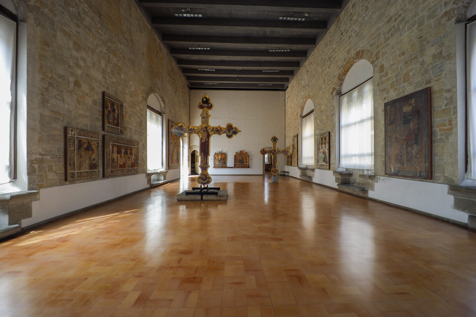 the sculpture room of palazzo abatellis with medieval capitals on low metal supports