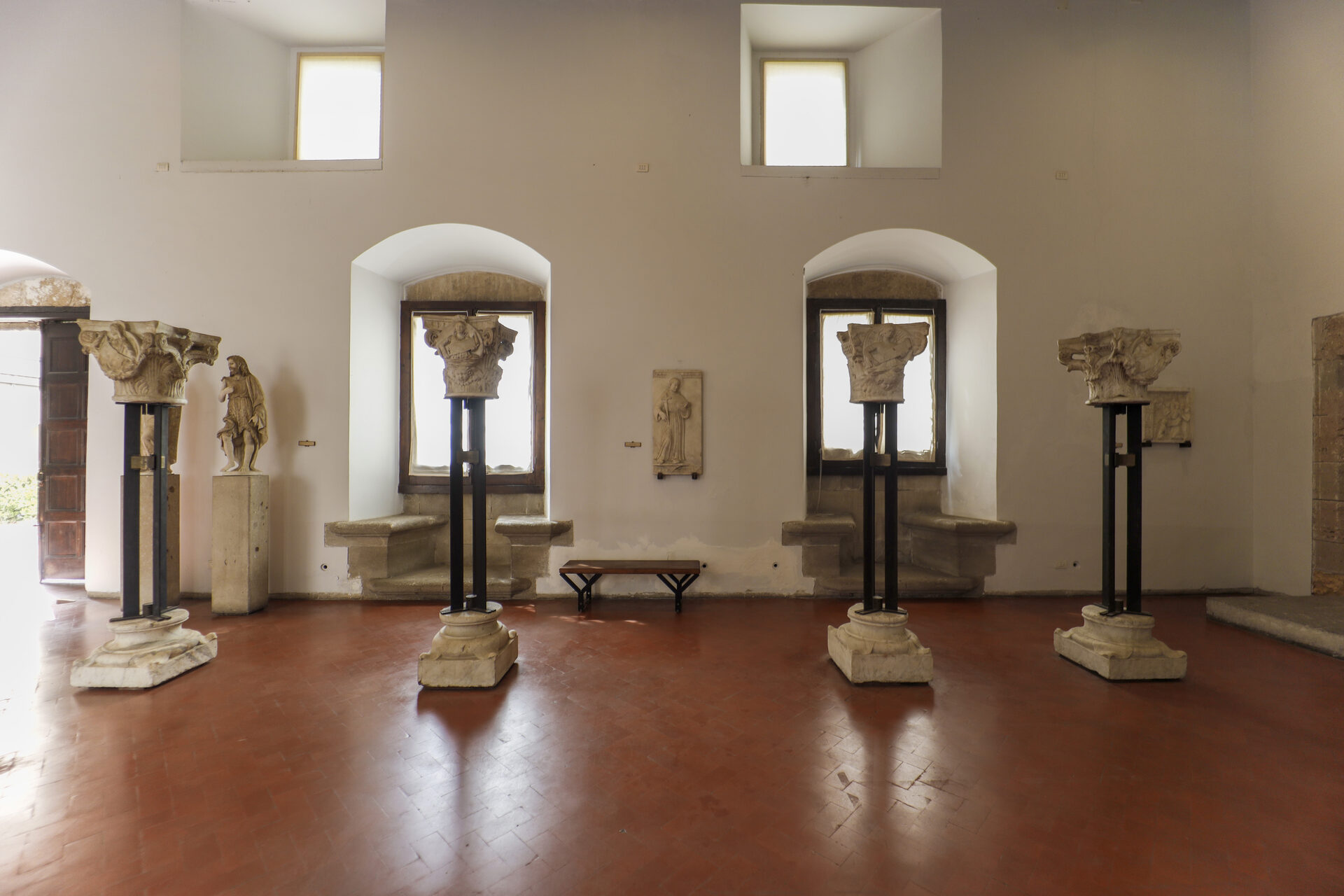 a gallery in palazzo abatellis with the beamed ceiling the windows and the works ranged along the wall