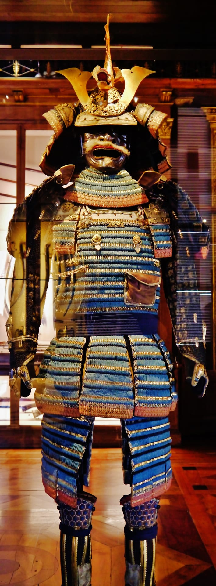 a japanese armour laced with light blue silk on display in the royal armoury in turin