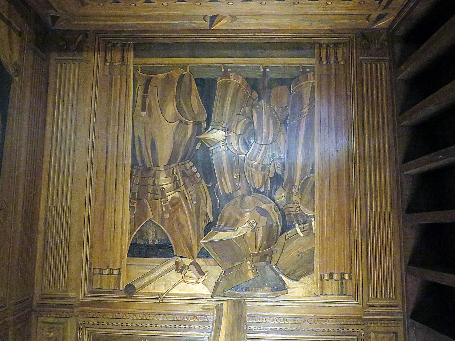 trompe-l’oeil wood inlay of the cabinet with the duke’s armour