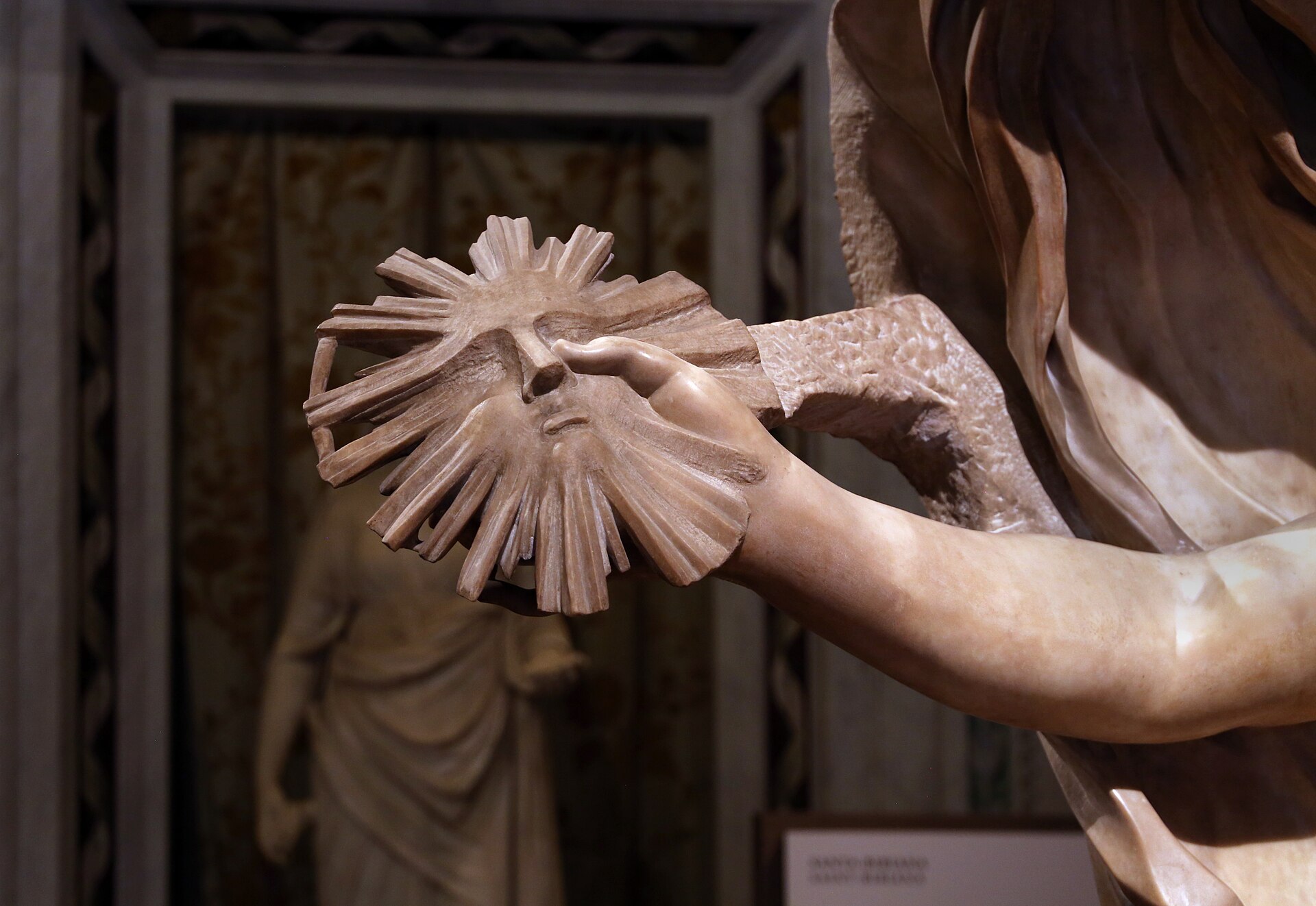 The carved sun that Truth holds in her right hand